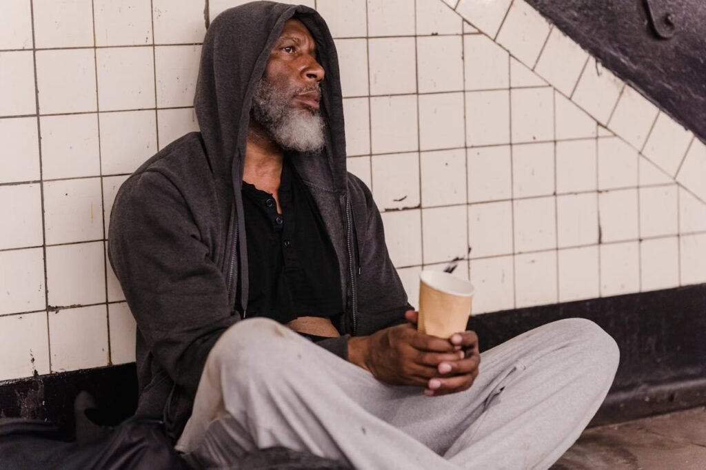 Homeless Man Wearing His Hoodie Jacket